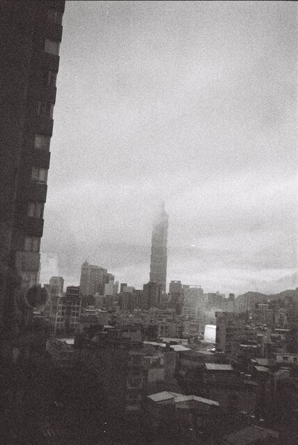 taipei 101 dissolving into fog above low rooftops